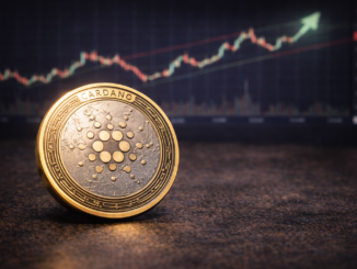 A Cardano (ADA) cryptocurrency token placed on a table with a blurred upward-trending market chart in the background.